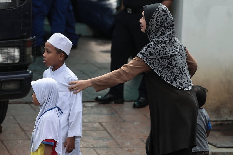 A relative of a teenage student cries after a fire broke out at a religious school in Jalan Datuk Keramat, Kuala Lumpur, Malaysia. Fazry Ismail / EPA