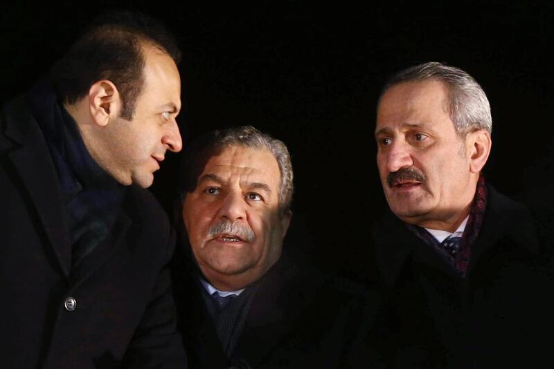 Turkey’s interior minister Muammer Guler (centre) and economy minister Zafer Caglayan (right), who have both resigned, speak to another minister, Egemen Bagis, (left) as they wait for Prime Minister Recep Tayyip Erdogan to arrive in Ankara on December 24. Adem Altan / AFP





