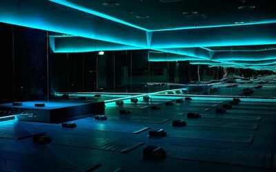 Warm yoga sessions at Shimis are conducted in a darkened room with strip lighting, with the temperature set at 32°C