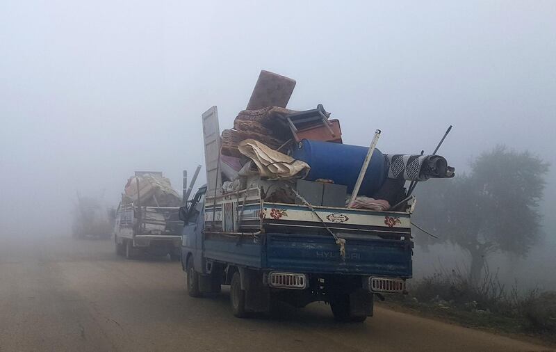 Vehicles loaded with furniture and other items drive along a highway near Sarmada in Syria's north-west Idlib province. AFP