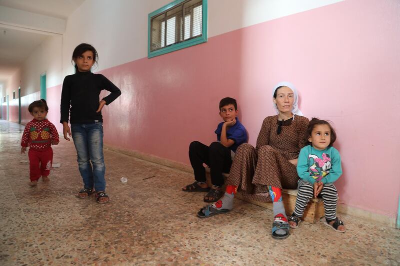 A displaced Kurdish family who fled their home town of Ras al-Ain city take temporary shelter in a school building at Tal Tamr town, northeast of Syria. Turkey has launched an offensive targeting Kurdish forces in north-eastern Syria, days after the US withdrew troops from the area.  EPA