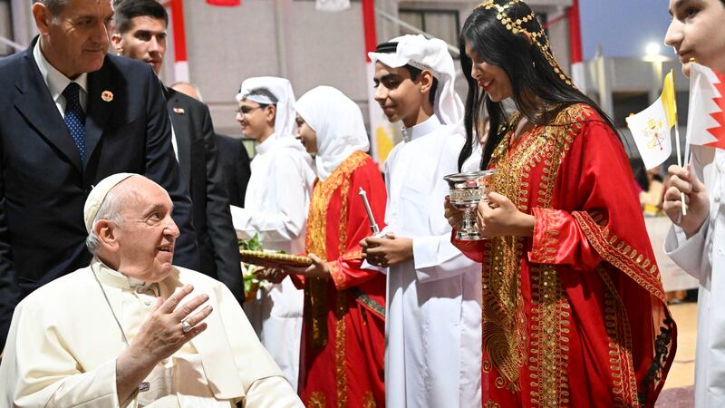 Pope Francis is welcomed by girls and boys in traditional dress during a meeting with young people in Sacred Heart School in Manama, Bahrain. EPA