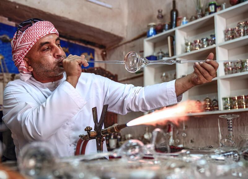 Abu Dhabi, United Arab Emirates, July 23, 2019.  VB:  Photo project at the Heritage Village, Corniche.  Local craftsworkers conduct workshops in traditional metalwork, pottery, glass blowing and Arabic cloak making. --  Noor Ahmad-47, Arabic glass blowing artist busy in his workshop at Heritage Villlage.
Victor Besa/The National
Section:  NA
Reporter: