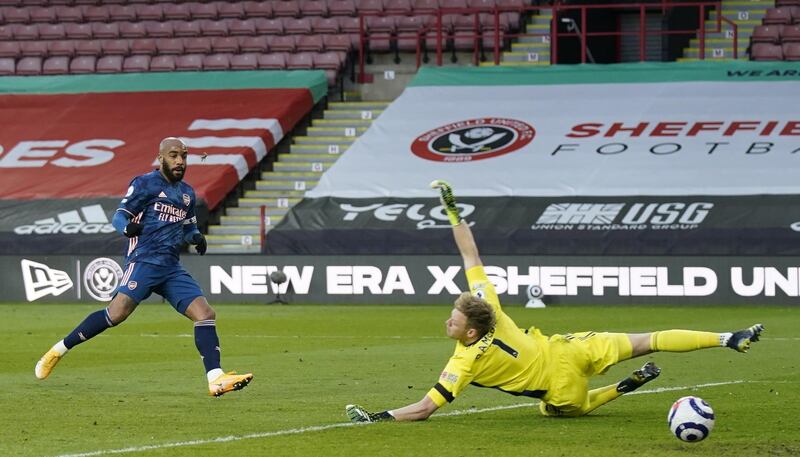 Arsenal's Alexandre Lacazette scores to open the scoring agaimnst Sheffield goalkeeper Aaron Ramsdale. EPA