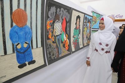 Shaima Ketati, a young girl with a hearing disability, leading a tour for a group of visitors at her art exhibition, organized by the Tamer Institute