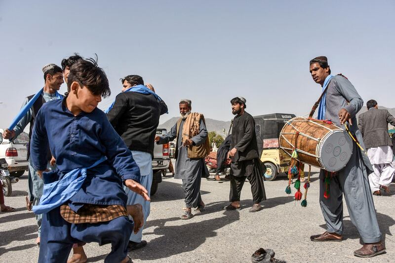 Men and youths dance as they celebrate the first day of 'reduction in violence' agreed between the Taliban, US and Afghan forces in Kandahar province.  AFP