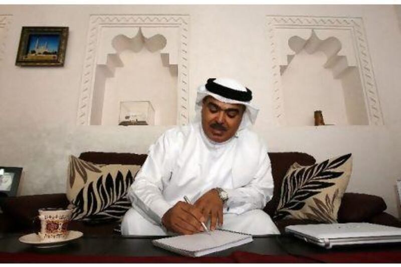 Abdulaziz al Musallam, the director of heritage and culture affairs at Sharjah's Department of Culture and Information, sketches the kahf al daba at his office. Pawan Singh / The National Below, sketches of creatures from Emirati folklore that have illustrated Mr al Musallam's books and papers.