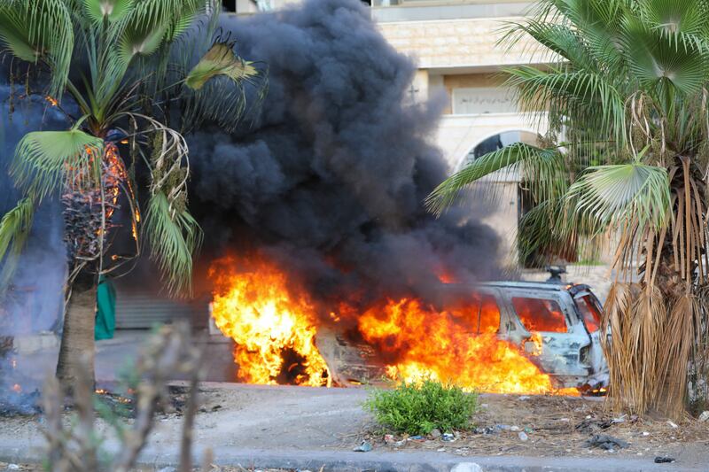 Flames engulf a vehicle following clashes in the Khalde area, south of the Lebanese capital.