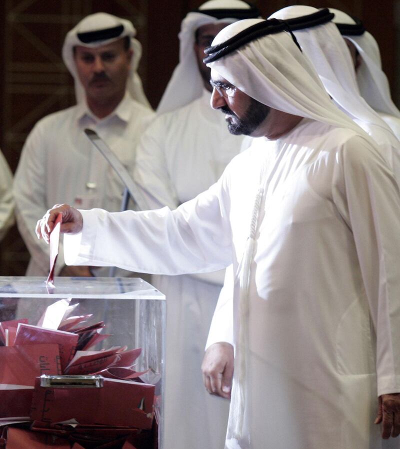 Sheikh Mohammeh bin Rashed al Maktoum, Vice President and Prime Minister of the United Arab Emirates, casts his vote at a polling stantion in Dubai, 18 December 2006. The second phase of indirect elections to an advisory council got under way in the United Arab Emirates today, two days after a woman was voted into office in the first ever national polls in the Gulf country. AFP PHOTO/KARIM SAHIB (Photo by KARIM SAHIB / AFP)
