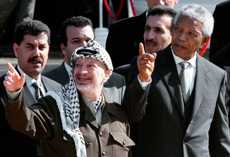 Mandela, right, and then Palestinian leader Yasser Arafat gesture during a meeting in Cape Town, South Africa. Sasa Kralj / AP Photo