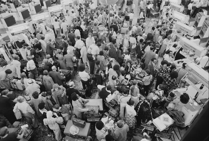 Passengers queue at Heathrow in August 1978. Getty