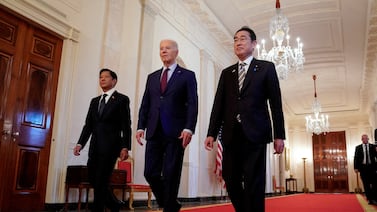 US President Joe Biden escorts Philippines President Ferdinand Marcos Jr, left, and Japan Prime Minister Fumio Kishida to their White House summit. Reuters