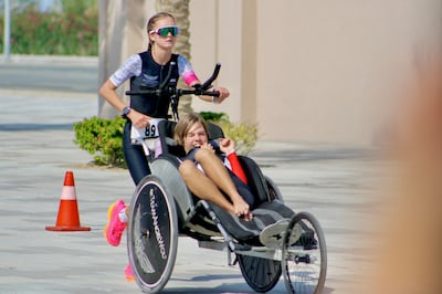 Rio Watson being pushed in a bike during a triathlon in the UAE with his sister, Tia. Photo: Team Angel Wolf