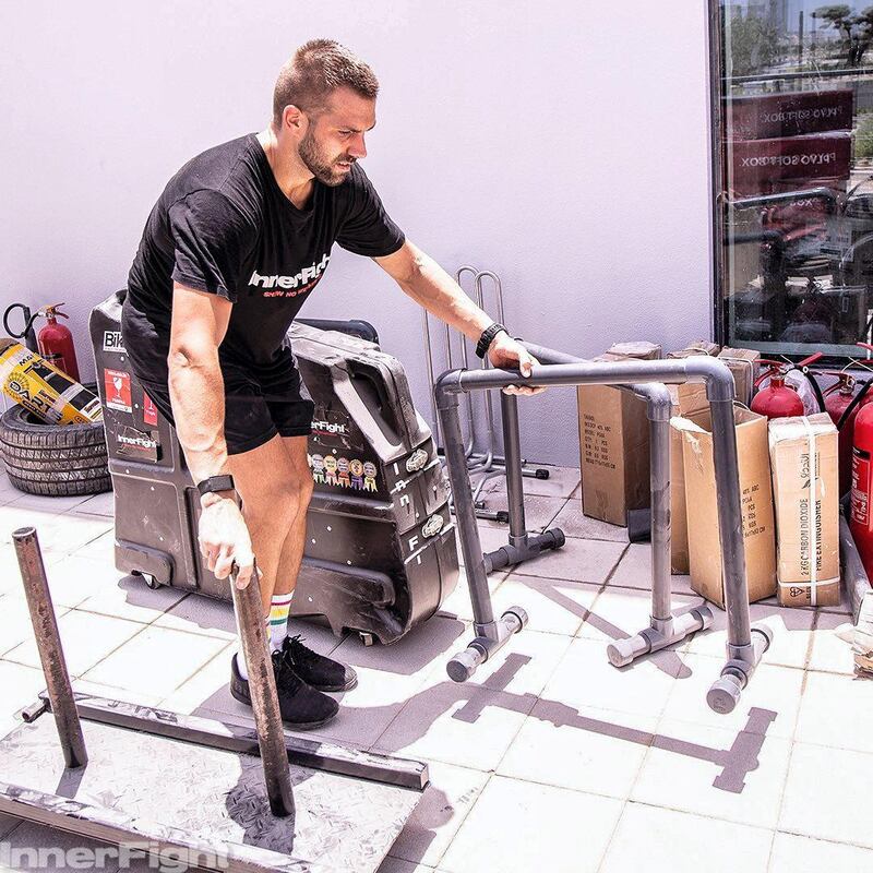 Rob Jones, one of the trainers at InnerFight, moves equipment.