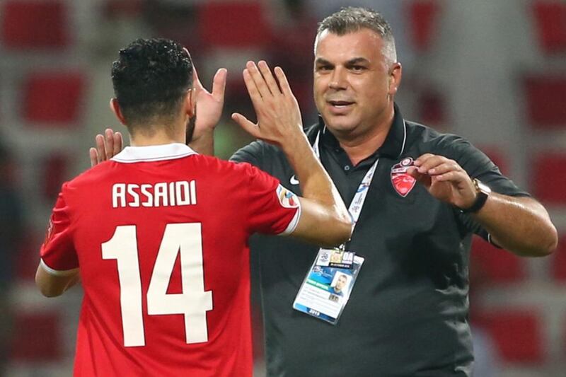Al Ahli coach Cosmin Olaroiu celebrates with Oussama Assaidi after the team's advancement to the Asian Champions League final. Marwan Naamani / AFP / October 20, 2015