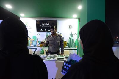 A Saudi police officer speaks to women at the driving event in Jeddah. Naser Al Wasmi/ The National