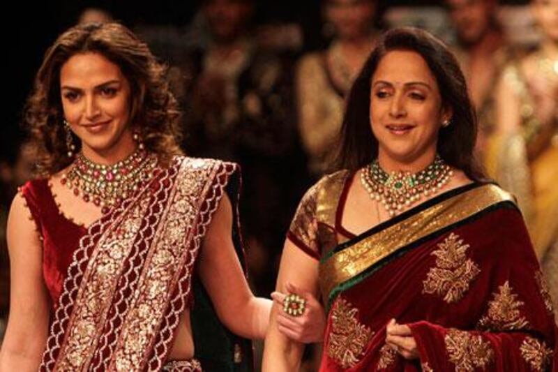 Bollywood actress Hema Malini, right, and her daughter Esha Deol display creations by designers Shyamal and Bhumika.