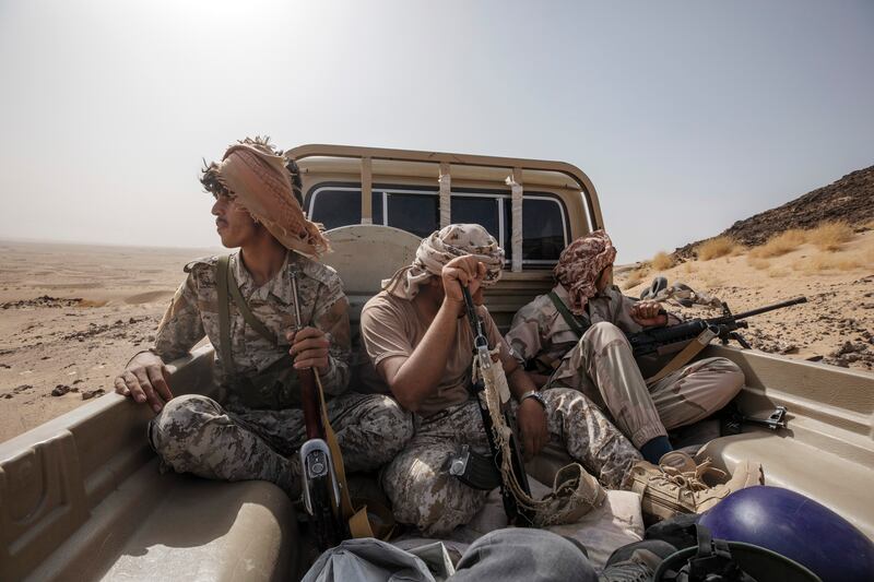 Yemeni fighters leave after clashes with Houthi rebels on the Kassara front line near Marib. AP