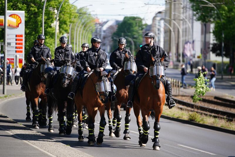 Police officers on horses patrol outside the Alte Foersterei stadium. EPA
