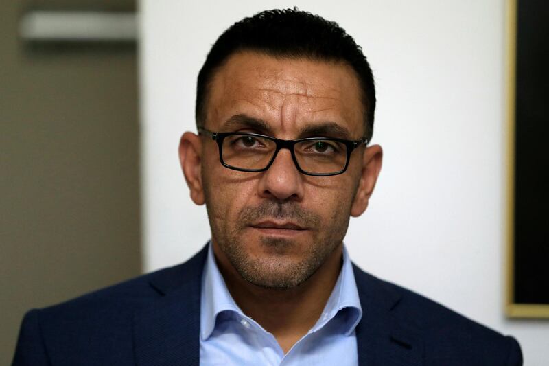 Governor of Jerusalem for the Palestinian Authority Adnan Ghaith poses for a photograph in his office at the Palestinian Ministry of Jerusalem affairs' headquarters in the occupied West Bank town of al-Ram, near Jerusalem, on November 4, 2018. - Israeli forces raided the offices of the Palestinian governor of Jerusalem on November 4, authorities said, after reports of an investigation related to a land sale. Israeli authorities confirmed the raid in Al-Ram, just on the other side of Israel's separation wall from Jerusalem in the occupied West Bank, but provided few details. (Photo by Ahmad GHARABLI / AFP)