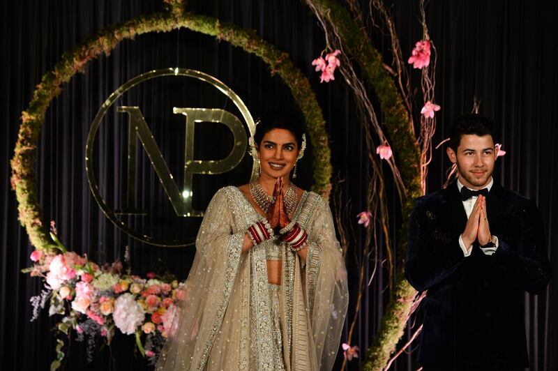 Newlyweds Priyanka Chopra, 36, and Nick Jonas, 26, pose for a photograph during a reception at a hotel in New Delhi on December 4, 2018. Photo: AFP