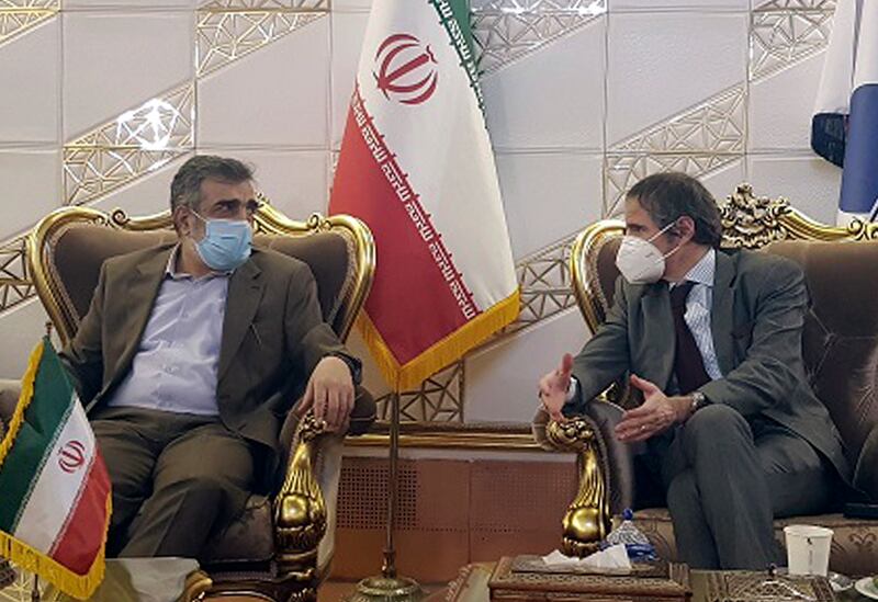 FILE - In this Feb. 20, 2021, file photo, Director General of International Atomic Energy Agency, IAEA, Rafael Mariano Grossi, right, speaks with spokesman of Iran's atomic agency Behrouz Kamalvandi upon his arrival at Tehran's Imam Khomeini airport, Iran. Iran has said it plans to cease its implementation of the "Additional Protocol," a confidential agreement between Tehran and the IAEA reached as part of the landmark nuclear accord that grants the U.N. inspectors enhanced powers to visit nuclear facilities and watch Iran's program. (Atomic Energy Organization of Iran via AP, File)