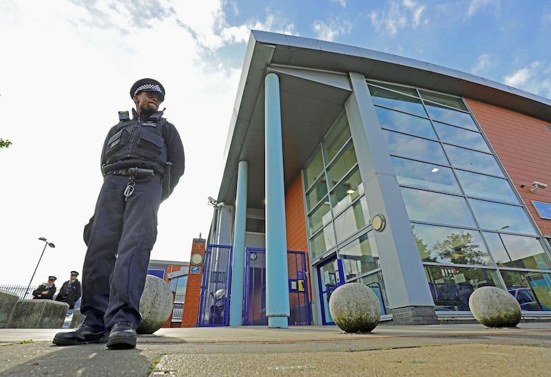 A police officer stands outside Croydon Custody Centre where a police officer was shot in the early hours of Friday, Sept. 25, 2020, in Croydon, England. A British police officer has been shot dead inside a London police station while detaining a suspect. London’s Metropolitan Police force said the officer was shot at the Croydon Custody Center in the south of the city early Friday.  (Aaron Chown/PA via AP)