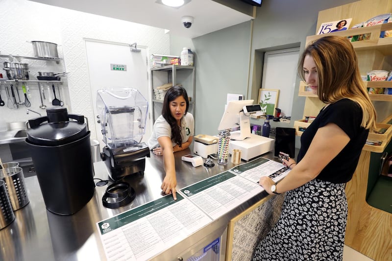 Abu Dhabi, United Arab Emirates - September 15, 2019: Harshita Mathur takes Rosie's order. A look at the newly opened Sweet Greens café. They have a special focus on being healthy and environmentally friendly. Sunday the 15th of September 2019. Rihan Heights, Abu Dhabi. Chris Whiteoak / The National