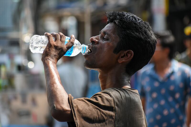 A man drinks water at a street side in Kolkata. Reuters