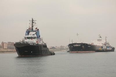 The MV Glory cargo vessel, that was briefly stranded in the Suez Canal in January due to a technical fault, is assisted by tugs. Reuters