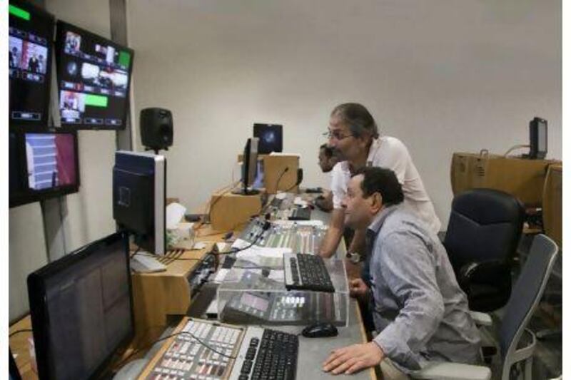 Omar Elkeddi (centre), chief news editor at Libya TV, works with his colleagues in the gallery. Credit: Raymond Bobar