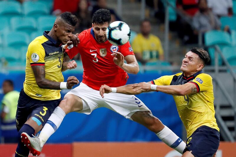 Ecuador defender Robert Arboleda challenges Chile's Igor Lichnovsky Osorio. EPA