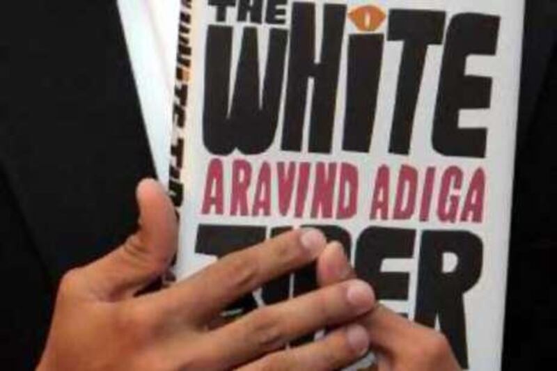 Indian author Aravind Adiga, seen with a copy of his book, The White Tiger, following an award ceremony, at the Guildhall, in the City of London, Tuesday, Oct. 14, 2008. Aravind Adiga won the prestigious Man Booker prize Tuesday for his first novel "The White Tiger." Adiga won the 50,000 pound (US$87,000) prize for a novel about a protagonist who will use any means necessary to fulfill his dream of escaping impoverished village life for success in the big city. (AP Photo/Alastair Grant)
