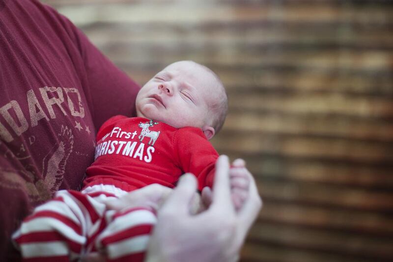 Turner Alistair, 5 days old, moments after taking his first photo with Santa at Abu Dhabi Mall. Mona Al Marzooqi / The National
