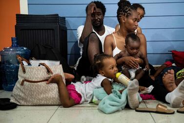 Ronald Samuel and his wife Kimberley Samuel shelter with their children in Marsh Harbor International Airport after Hurricane Dorian. AFP