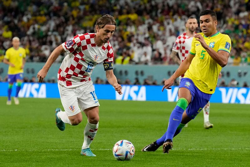 Croatia's Luka Modric under pressure from Casemiro of Brazil. AP