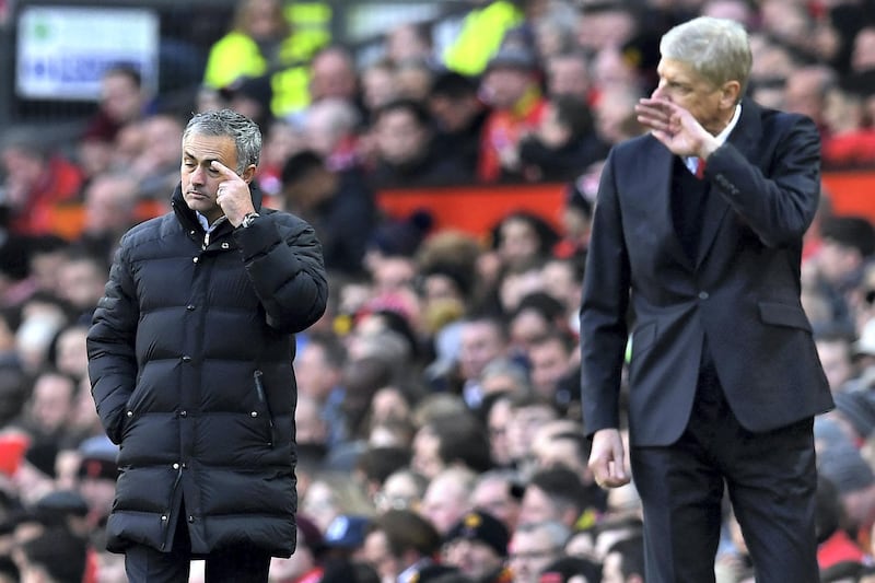 Manchester United's Portuguese manager Jose Mourinho (L) and Arsenal's French manager Arsene Wenger react as they watch their players from the touchline during the English Premier League football match between Manchester United and Arsenal at Old Trafford in Manchester, north west England, on November 19, 2016. / AFP PHOTO / Paul ELLIS / RESTRICTED TO EDITORIAL USE. No use with unauthorized audio, video, data, fixture lists, club/league logos or 'live' services. Online in-match use limited to 75 images, no video emulation. No use in betting, games or single club/league/player publications.  / 