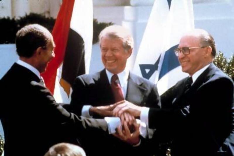 Egyptian President Anwar Sadat, left, US President Jimmy Carter, centre, and Israeli Prime Minister Menachem Begin clasp hands outside the White House on March 26, 1979 after signing a peace treaty between Egypt and Israel.