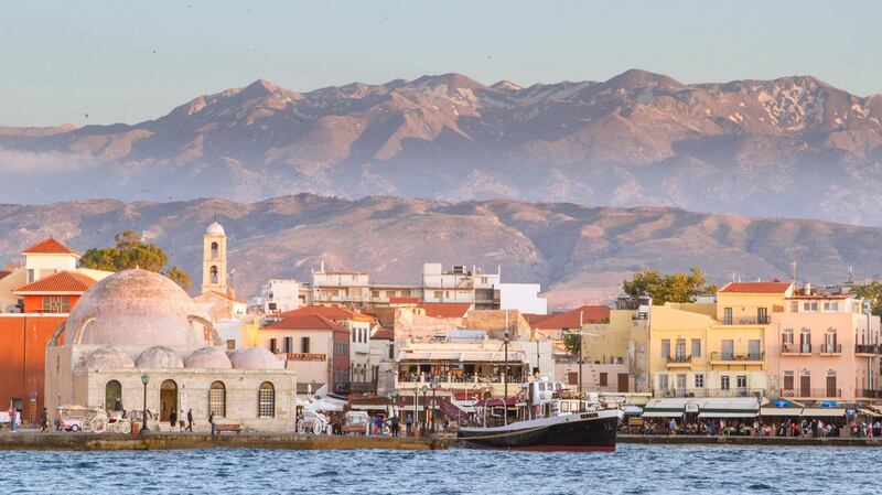 View of Chania harbor with white mountains on background.