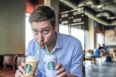 Daniel Sanderson samples the new range of sugar-laden cheesecake frappuccinos at Starbucks, which medics described as an unhelpful arrival in the fight against obesity and diabetes. Victor Besa / The National