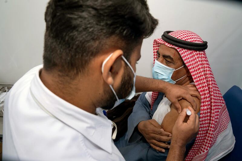 A Kuwaiti man, Abdulla al Anazi, gets a dose of Covid-19 vaccine in Kuwait City. Reuters