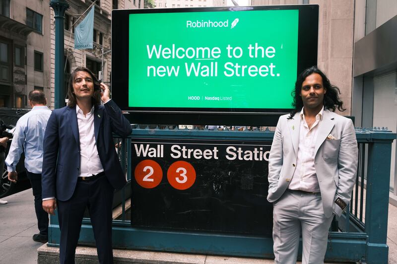 Baiju Bhatt, right, and Vlad Tenev, founders of online brokerage Robinhood, on New York's Wall Street after going public with an IPO. Getty Images / AFP