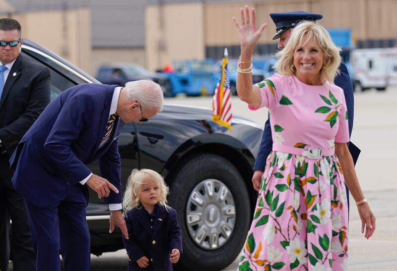 Mr Biden, his grandson Beau and the first lady before boarding Air Force One. AP