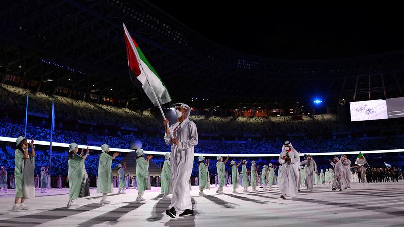 Flag bearer Yousuf Almatrooshi of the United Arab Emirates leads his contingent during the athletes' parade at the opening ceremony.