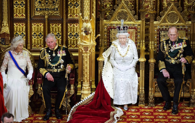 The couple are flanked by Queen Elizabeth II and Prince Phillip at the state opening of Parliament in the House of Lords in May 2013