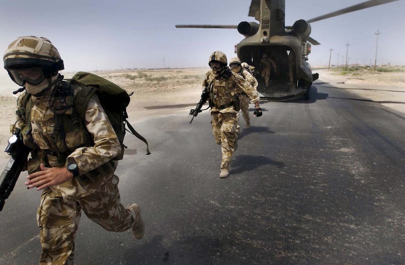 Soldiers from the Royal Welsh Fusiliers disembark a helicopter near Basra, Iraq, in 2004. Getty Images