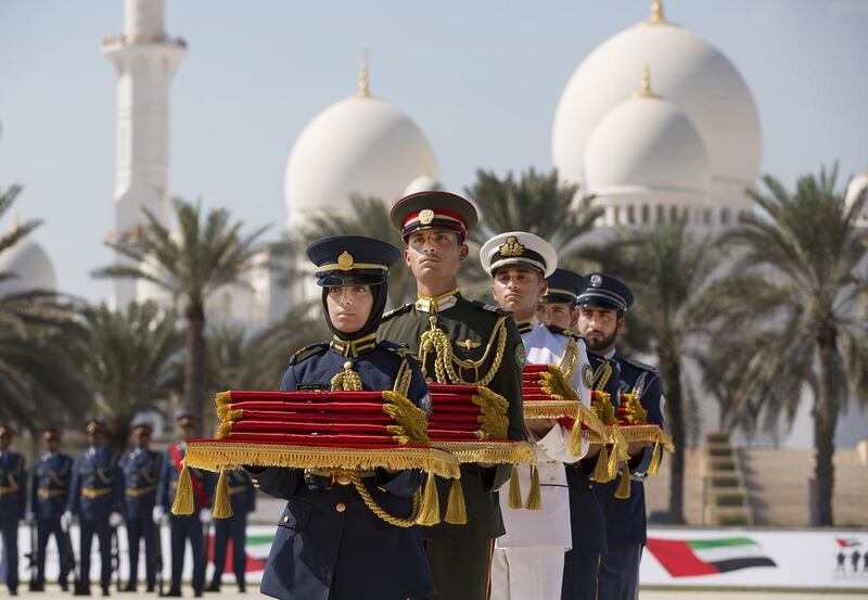 Members of the Armed Forces hold Martyrs’ Medals during the first Commemoration Day ceremony, honouring those who lost their lives in the performance of their duty.  Ryan Carter / Crown Prince Court – Abu Dhabi