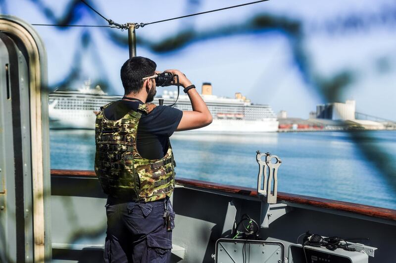 Abu Dhabi, U.A.E., February 14, 2019.  European Multi-Mission Frigate (FREMM), Carlo Margottini has docked at the Abu Dhabi Port with Commander Marco Guerriero.  --  a crew member secures the back side of the frigate.
Victor Besa/The National
Section:  NA
Reporter:  Charlie Mitchell