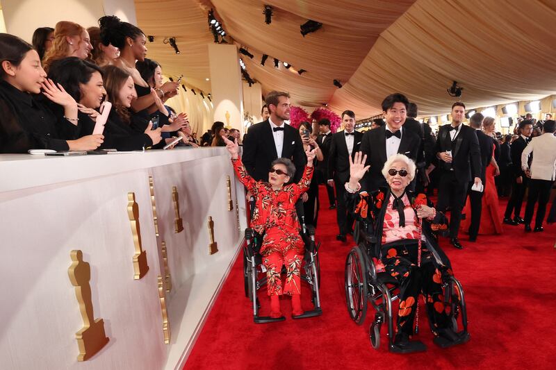Sam Davis, director Sean Wang and his grandmothers Yi Yan Fuei and Chang Li Hua make their way down the red carpet for the 96th Academy Awards in Hollywood. Reuters