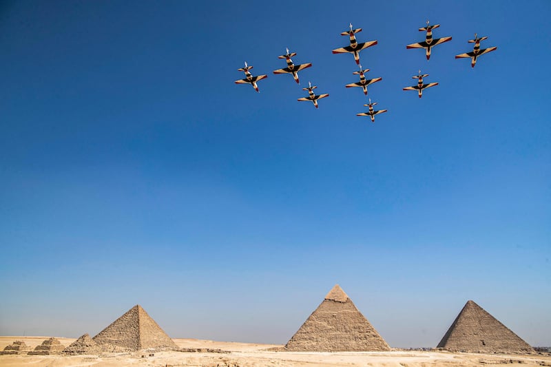 Aircraft of the Egyptian Air Force's 'Silver Stars' aerobatic team perform during the Pyramids Air Show above the Great Pyramid of Khufu, the Pyramid of Khafre and the Pyramid of Menkaure, on the south-western outskirts of Cairo. AFP